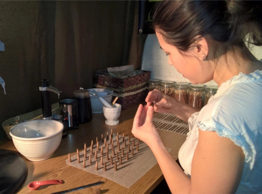 Hand-rolling natural lemongrass incense sticks in small batches in Canada